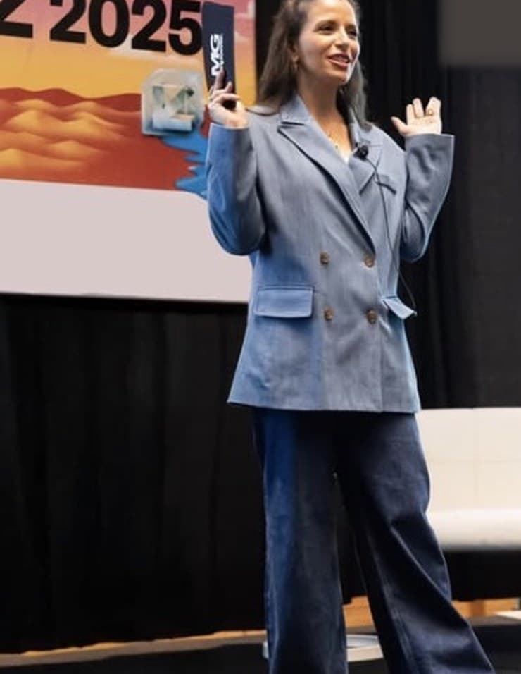 Maira Genovese speaking on stage at SXSW Austin